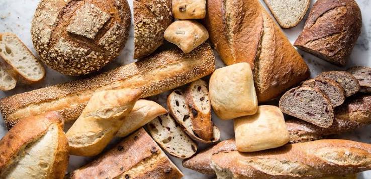Warm Oven baker preparing freshly baked bread and pastries
